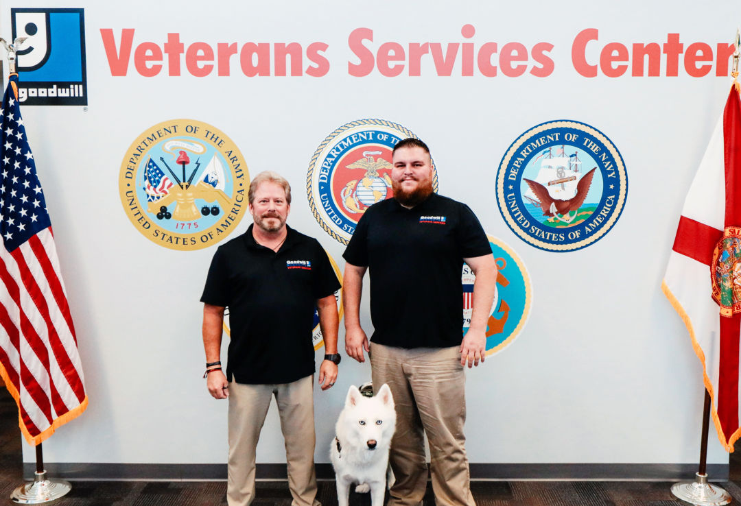 Veterans Services Program team member Randy Wright (left) and Todd Hughes, program manager, with service dog Ghost