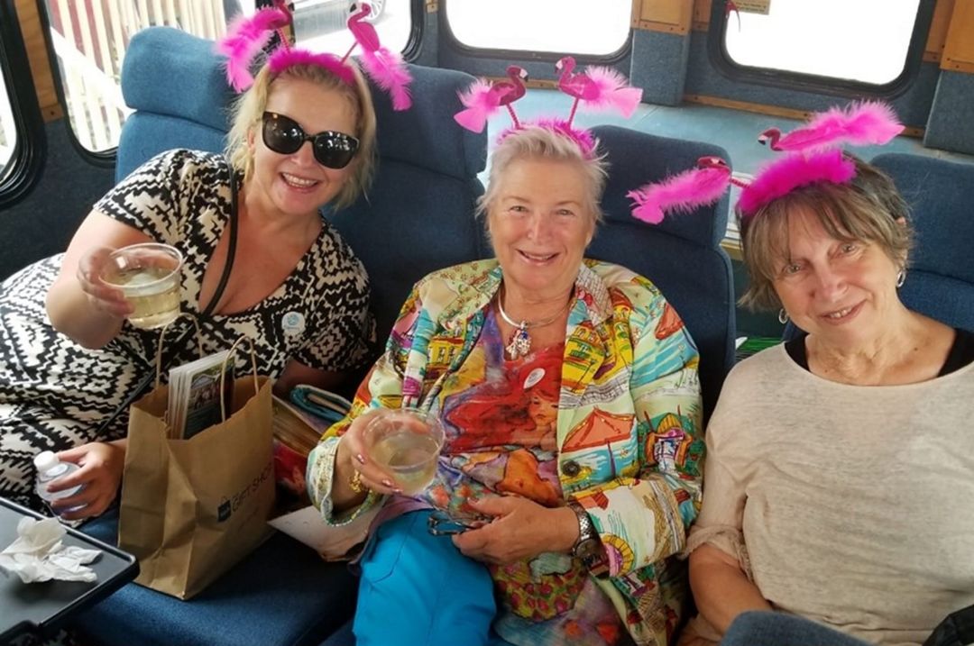 Friends wearing flamingo tiaras on a tour in Sarasota