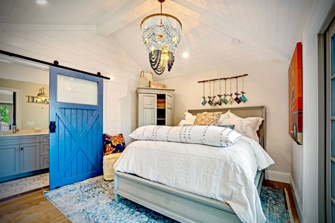 A bedroom with shiplap walls and ceiling.