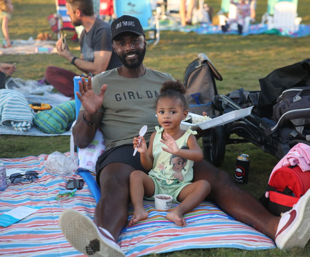 A family enjoys movie night at The Bay Park