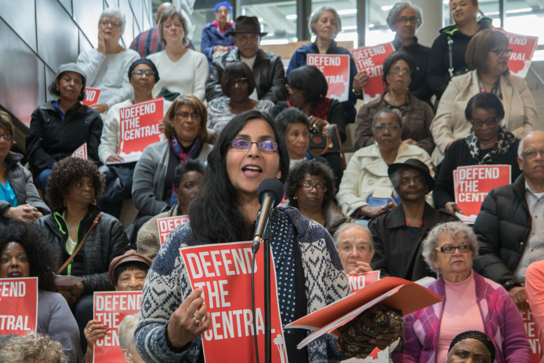 Kshama Sawant speaking in front of a crowd holding a "Defend the Central" sign.