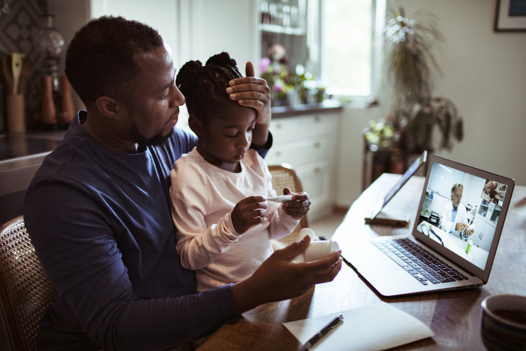 Parent with sick child doing a telemedicine visit