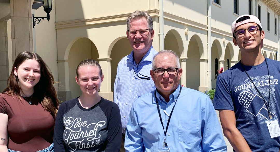 The Community News Collaborative consists of, from left, reporters Sarah Owens, Catherine Hicks, Jim DeLa and Alejandro Romero. Editor Eric Garwood, center, leads the team.