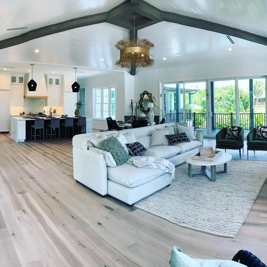 Black beams cross a shiplap ceiling.