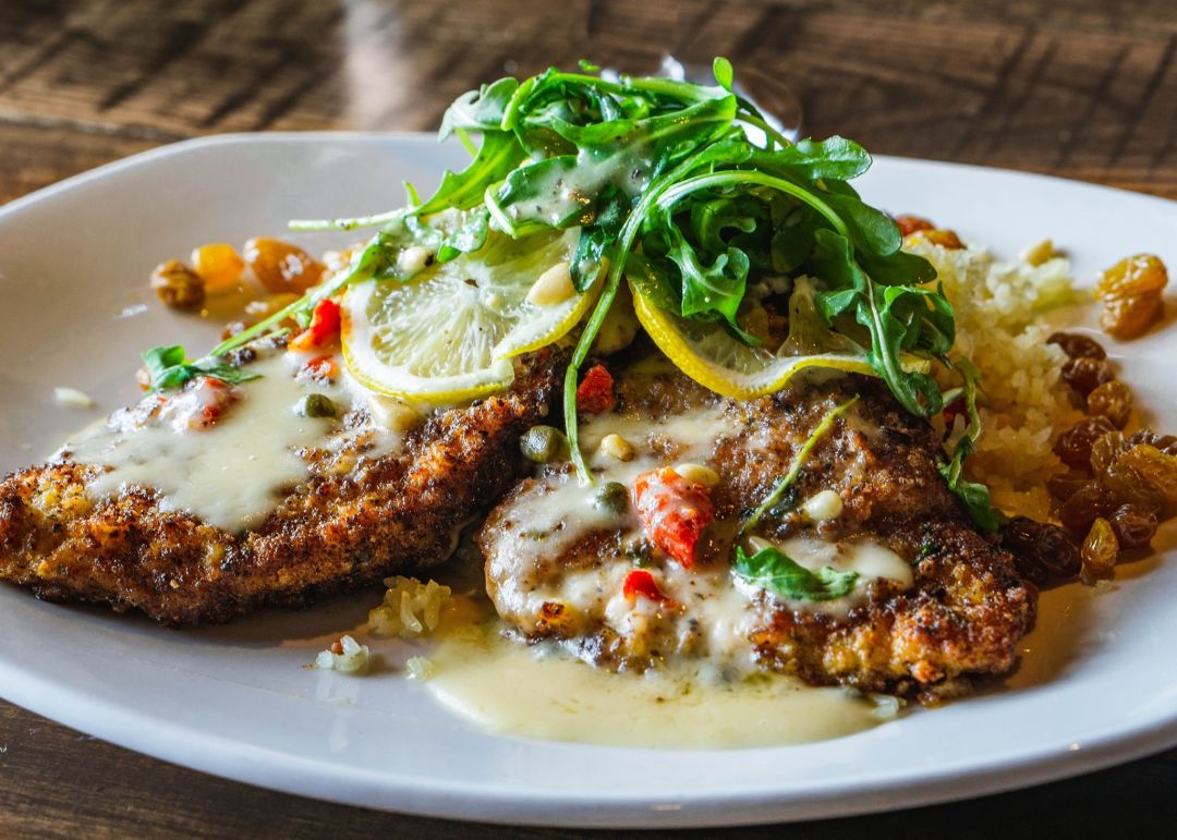 Chicken Milanese in a lemon-butter white wine reduction, sundried tomatoes, golden raisins, capers and pinenuts topped with a lemon-feta arugula salad.