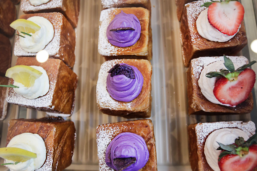 Birds-eye view of croissants in a display case.