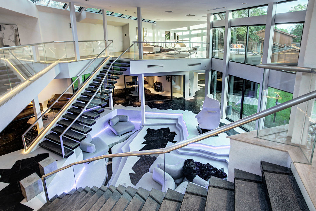 A fashionable interior with two staircases and modern ambience.