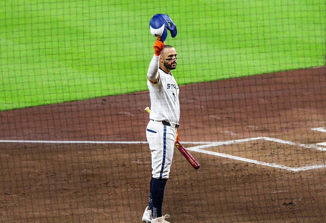 Astros Carlos Correa tips his hat at fans at Daikin Park.