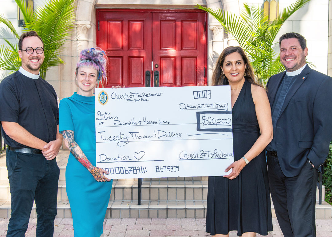 Megan Howel, in blue, founder and executive director for Second Heart Homes, receives a surprise grant check for $20,000 from Church of the Redeemer staff including Rev. David Svihel (far left), Anit Legare (second from right) and Rev. Chris Wood (far right).