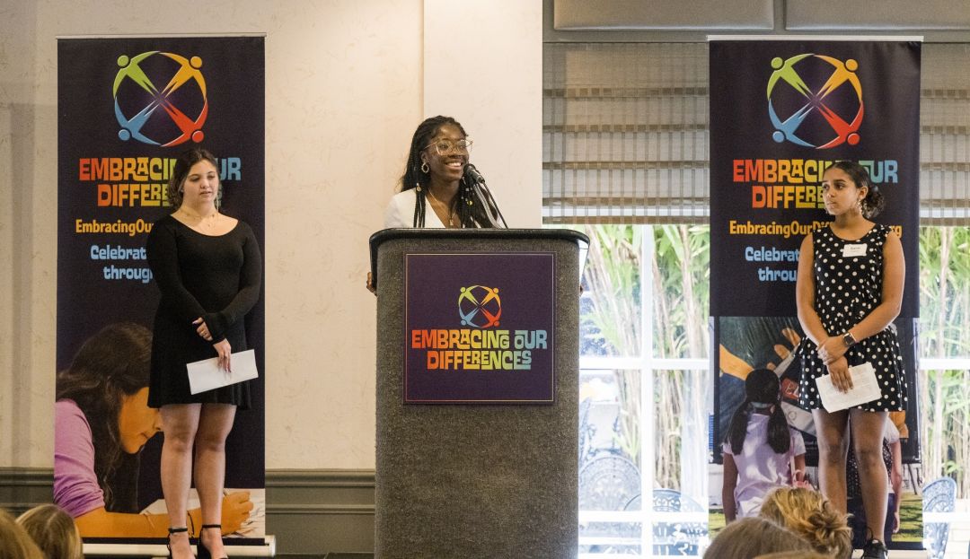 Students Sarai Castro, Jennica Charles and Lucia Warren speak at Embracing Our Differences' annual luncheon.