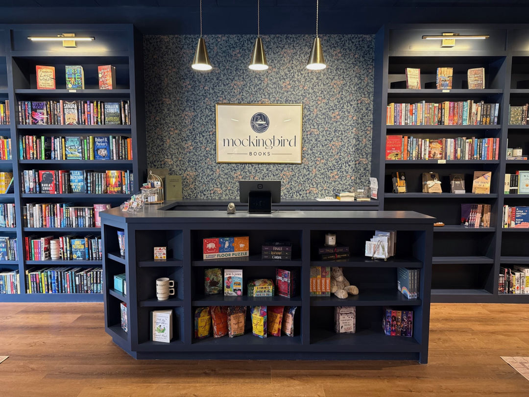 A bookstore counter with a sign reading