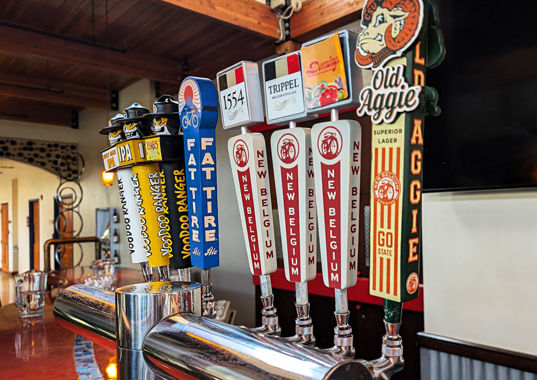 A row of beers on tap.