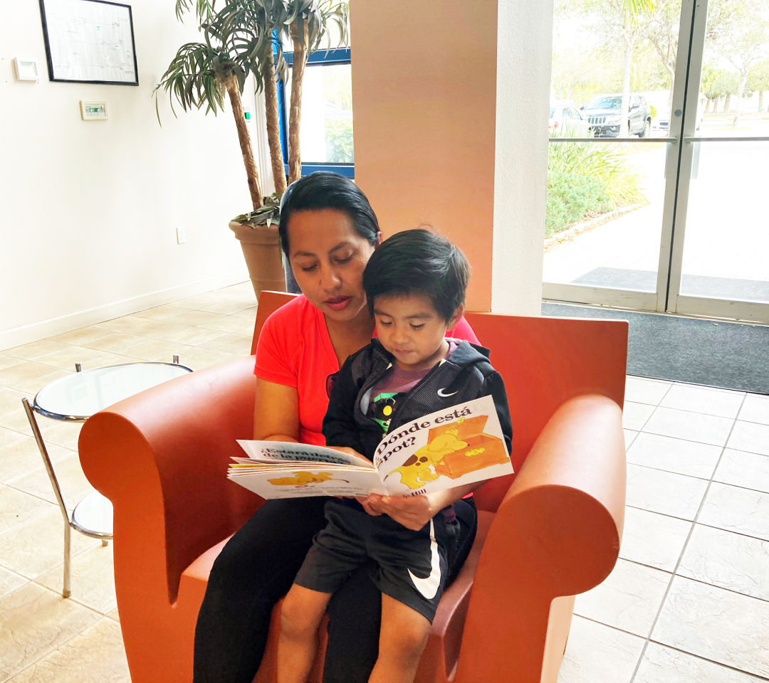 HIPPY mom Yulma Ruiz reads to her son, Milan Rosales