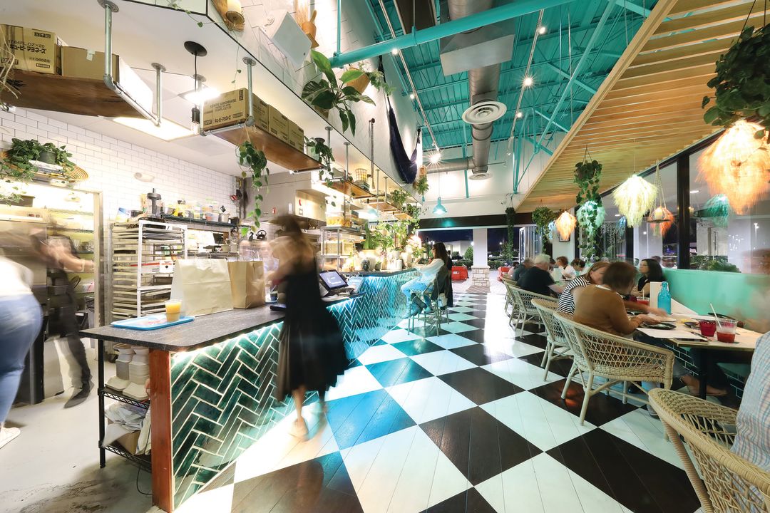 Silk lamps and hanging plants punctuate the restaurant's decor, which feels like an Anthropologie storefront mixed with your favorite groovy thrift shop