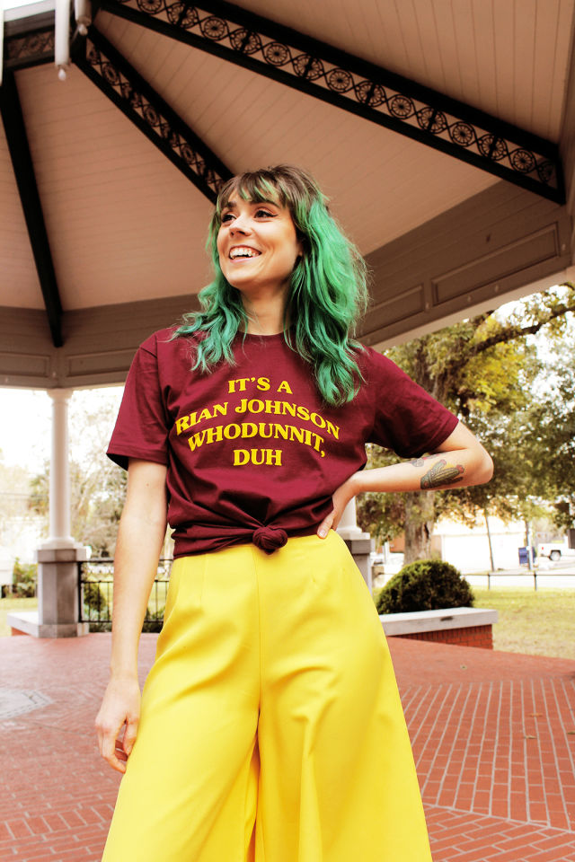 A woman poses in a Super Yaki T-shirt
