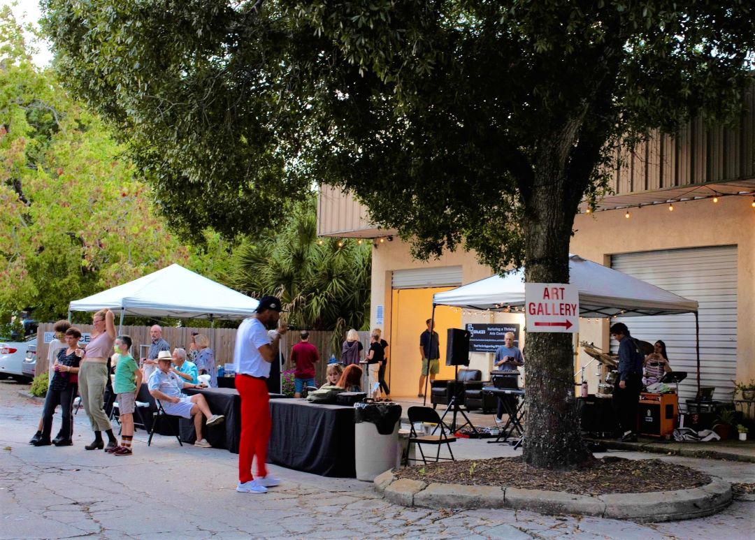 People enjoying art exhibit in warehouse district  in Park East neighborhood in Sarasota.