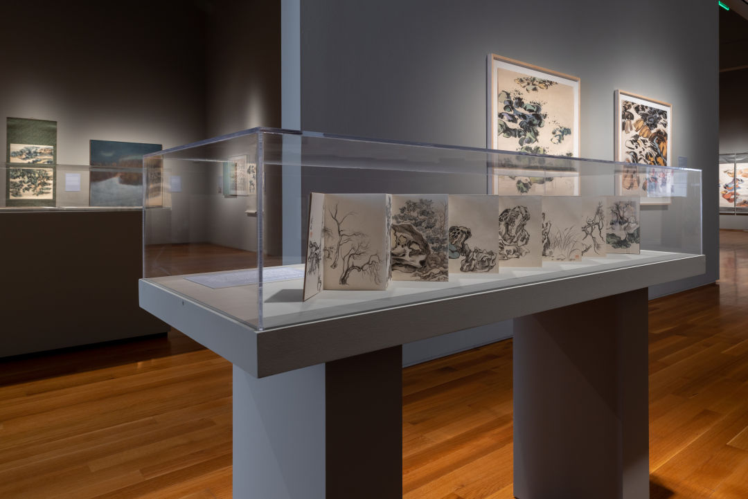 An art gallery with abstract expressionist artwork on display.