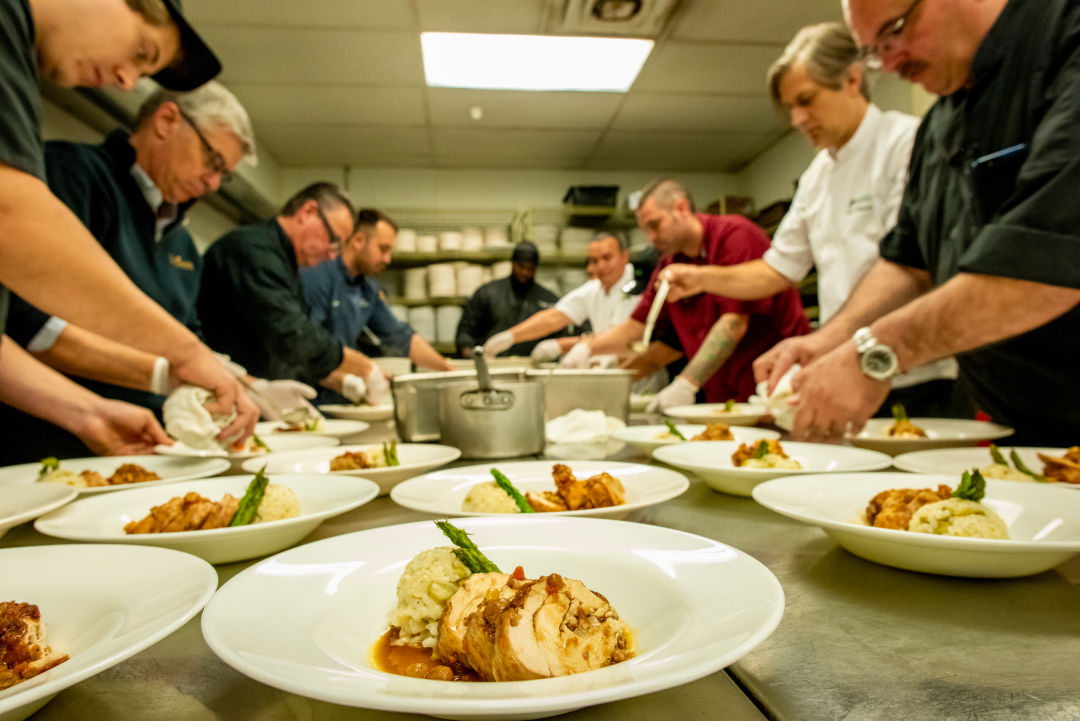 Sarasota-Manatee Originals chefs preparing a meal before an event.