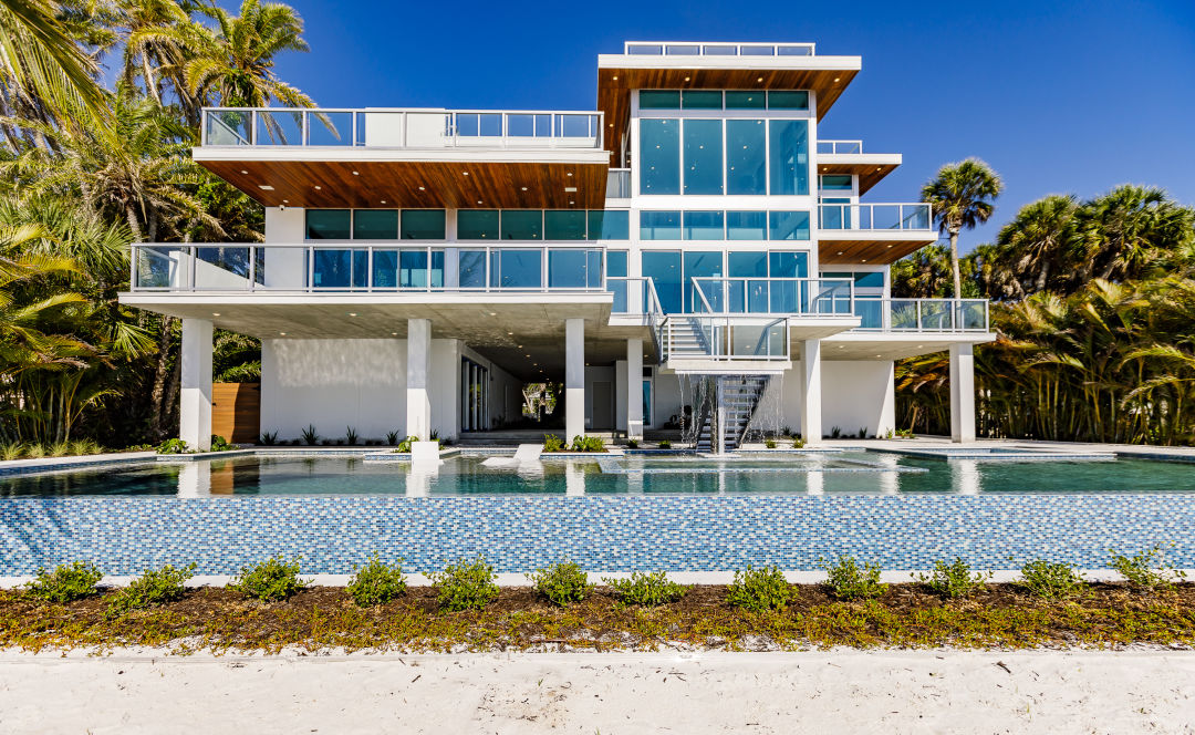 The back exterior has a pool overlooking Sarasota Bay.