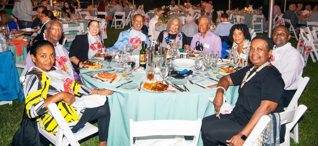 Guests enjoying heaping plates of lobster at the 42nd annual New College Foundation Clambake.