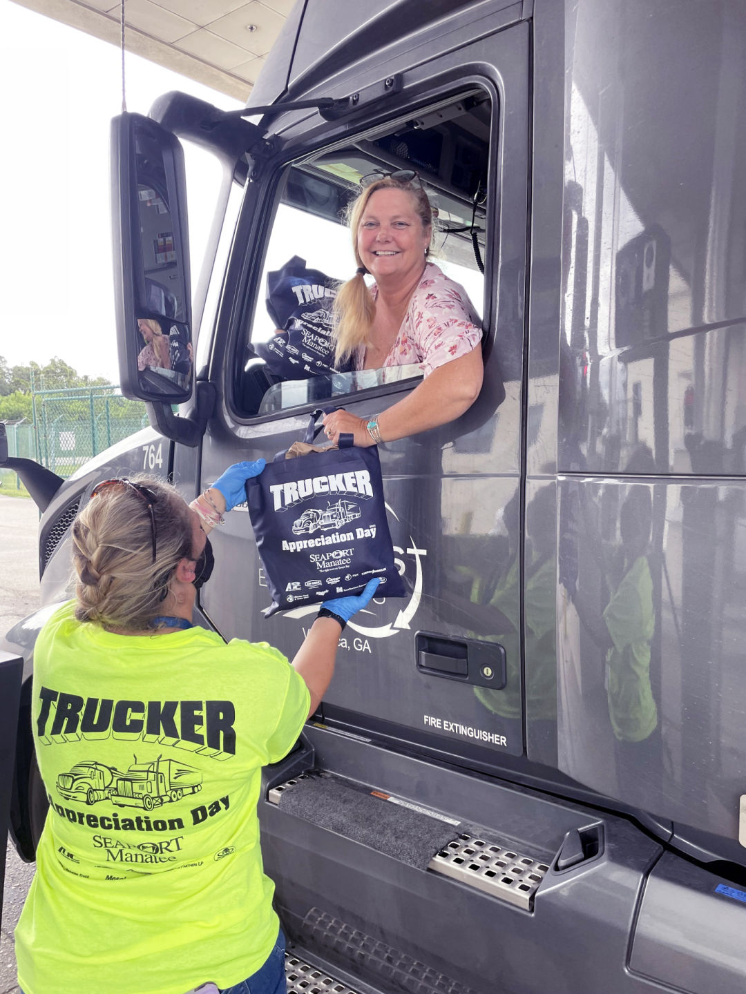 Lisa Rogers Orozco, who drives for Villa Rica, Georgia-based East-West Express Inc., smilingly accepts a goody bag as Port Manatee thanks professional drivers with its sixth annual Trucker Appreciation Day.