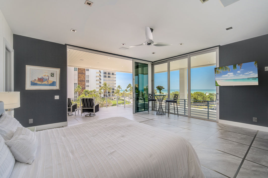 A bedroom with a view of Lido Beach.