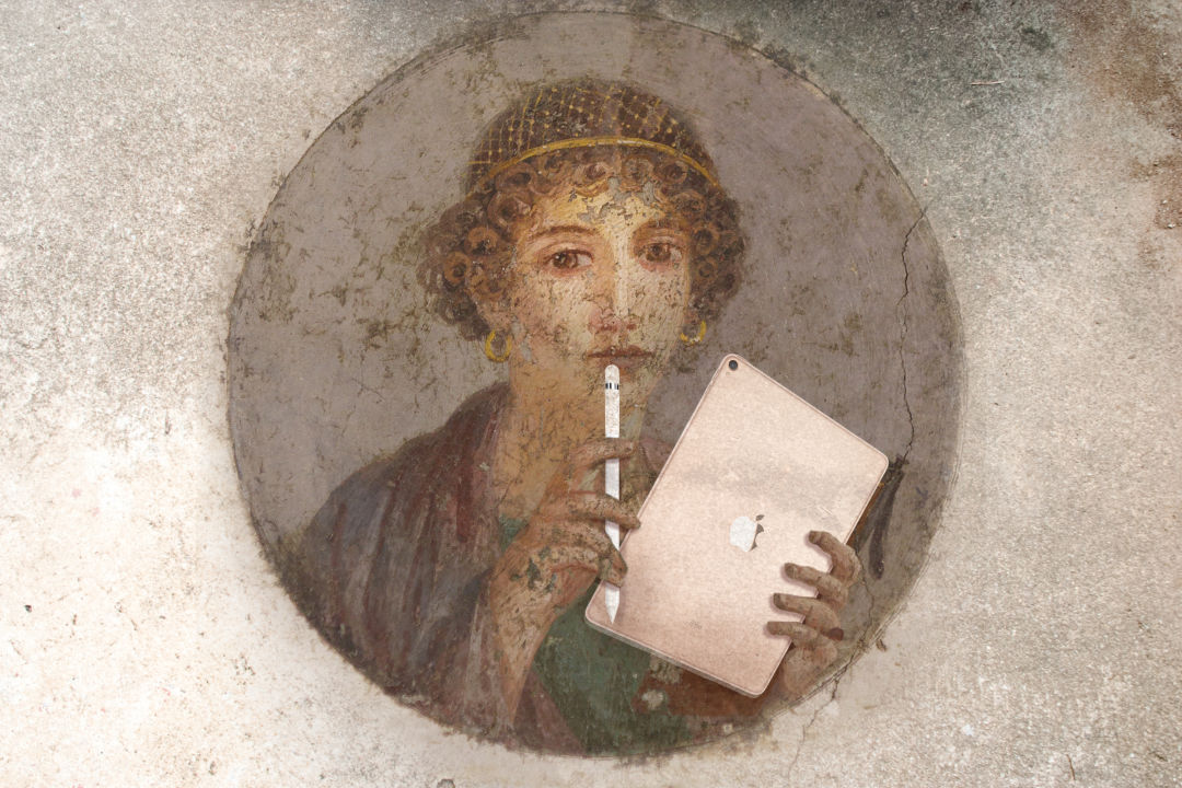 Vintage female poet holding a tablet and stylus while brainstorming.