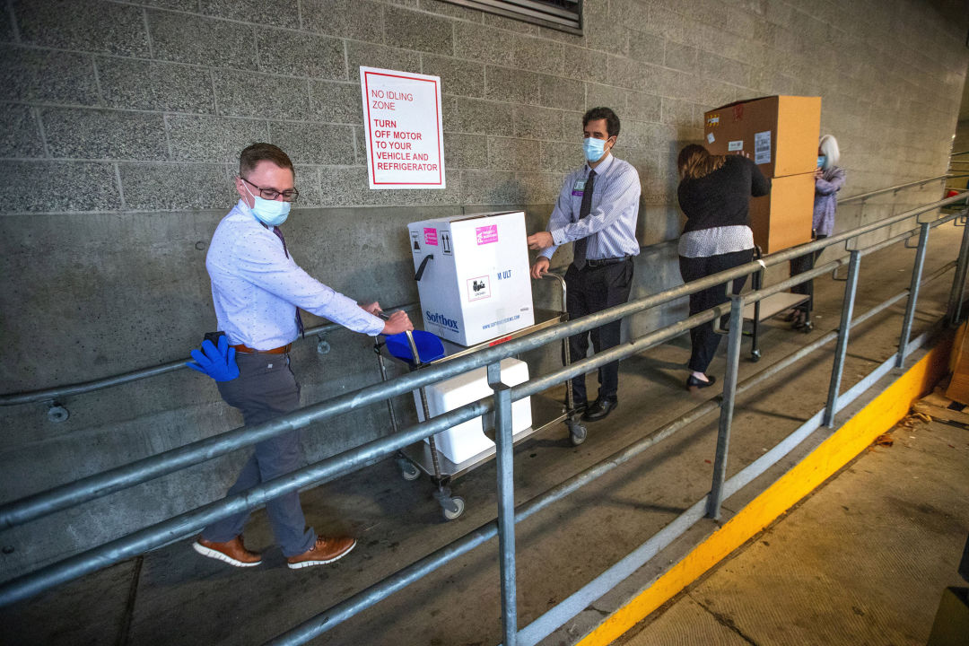 Workers carrying in coronavirus vaccine