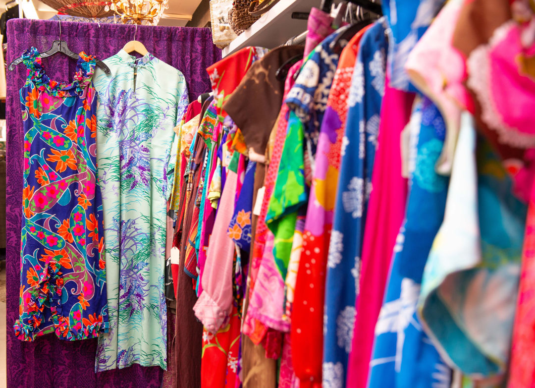 Rows of brightly colored vintage clothing at Canned Ham Vintage.