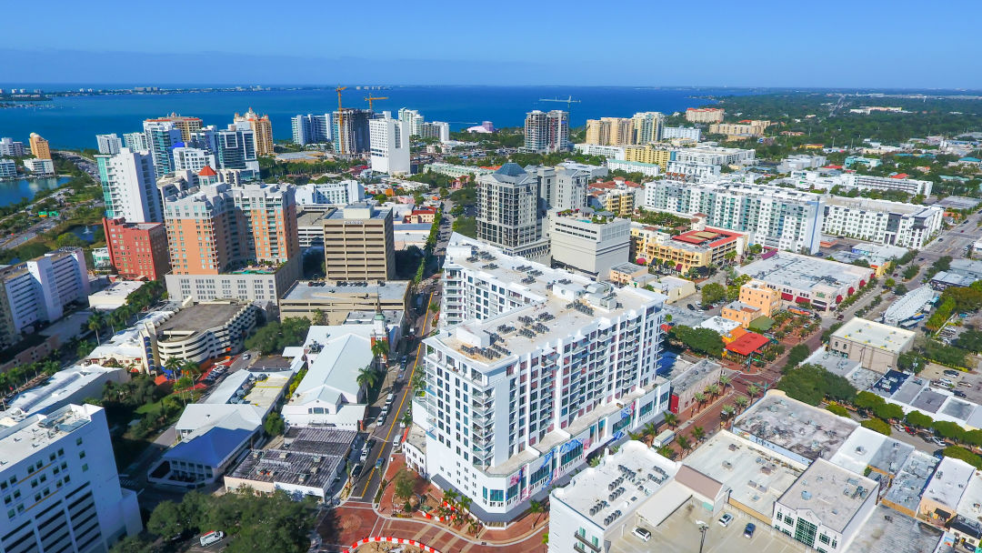 An aerial view of downtown Sarasota with condos and water.