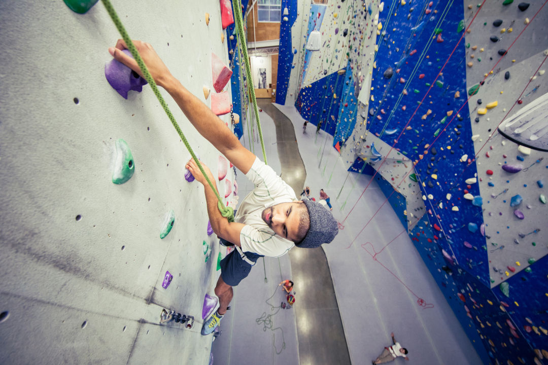 Sporty couple of climbers dressed in rock climbing outfit training