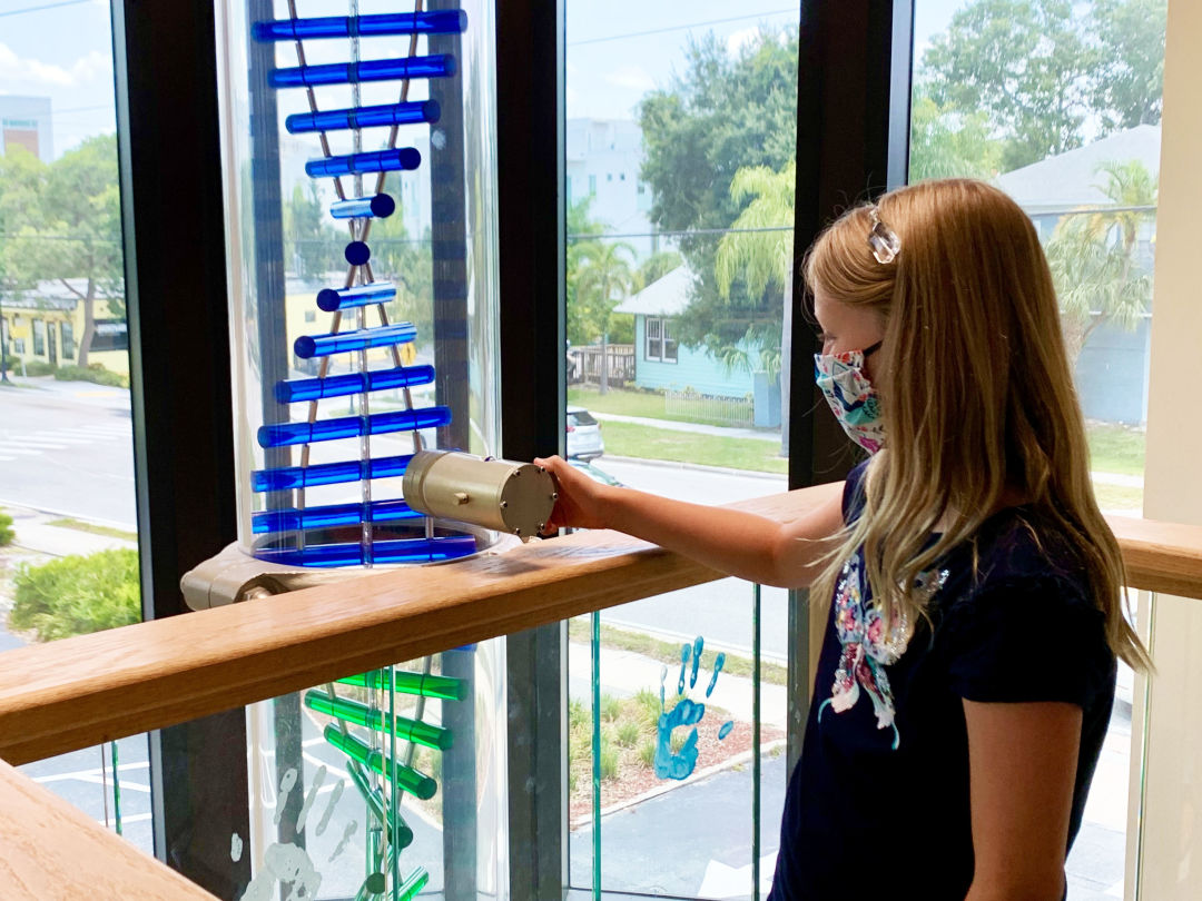 A child drops a marble into Child Protection Center's Pillar of Hope this year.