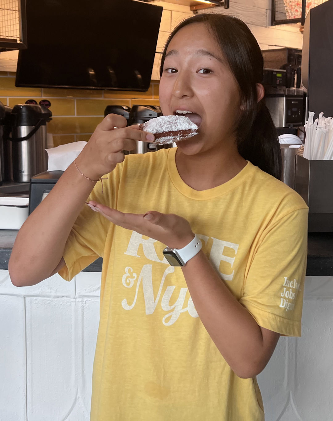 Sofia eating beignets at Rise & Nye's.