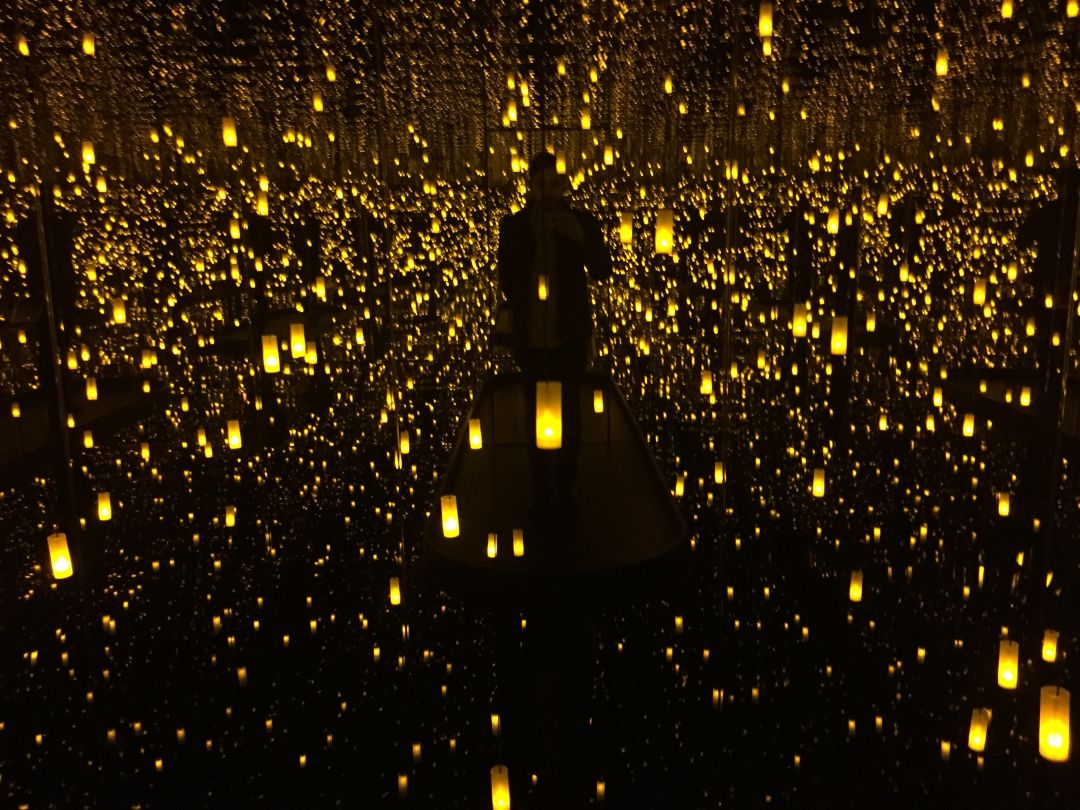 People use their smartphones to take pictures of the Yayoi Kusama