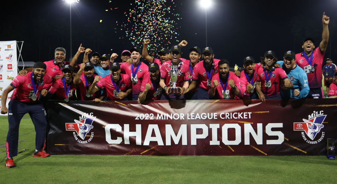 Seattle Thunderbolts hold a banner celebrating Minor League Cricket championship.