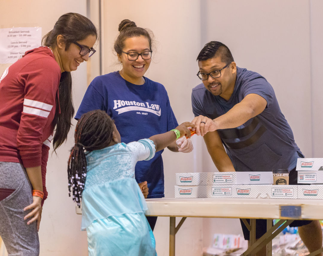 Volunteers hand out doughnuts at a NRG shelter on August 30, 2017.