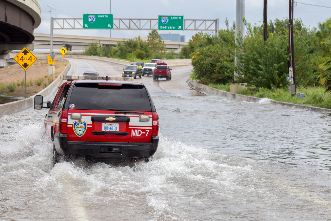 An emergency vehicle makes its way through floodwaters in Houston on August 27, 2017.