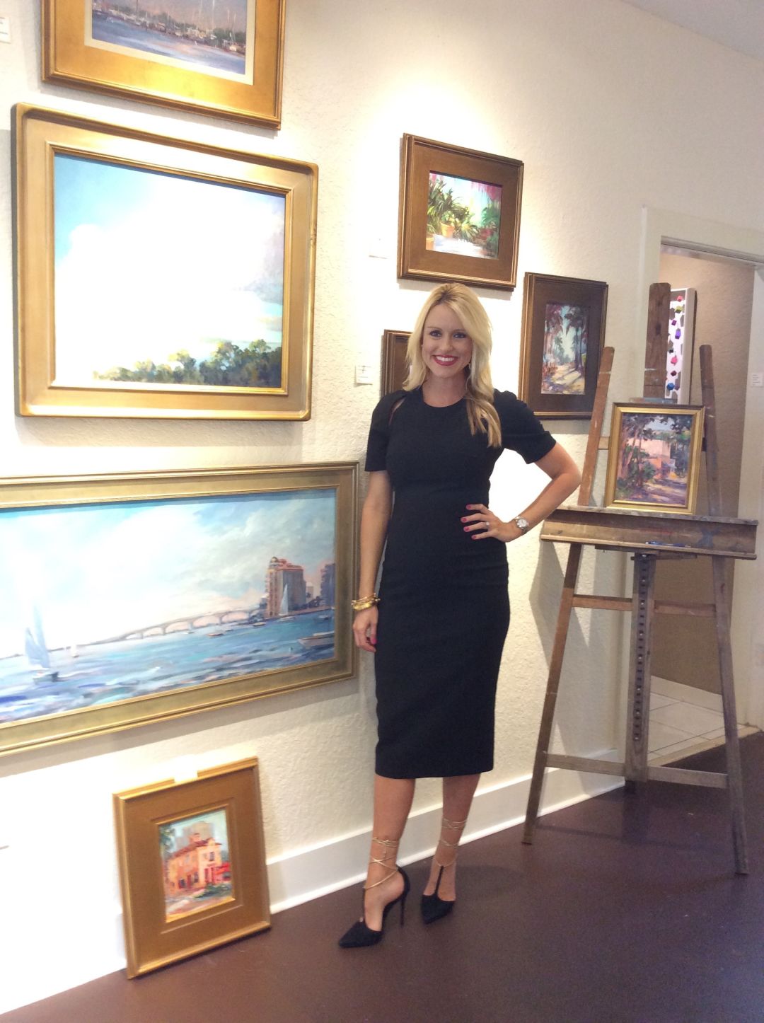 Montana in front of paintings by local artist linda richichi rrfm1x