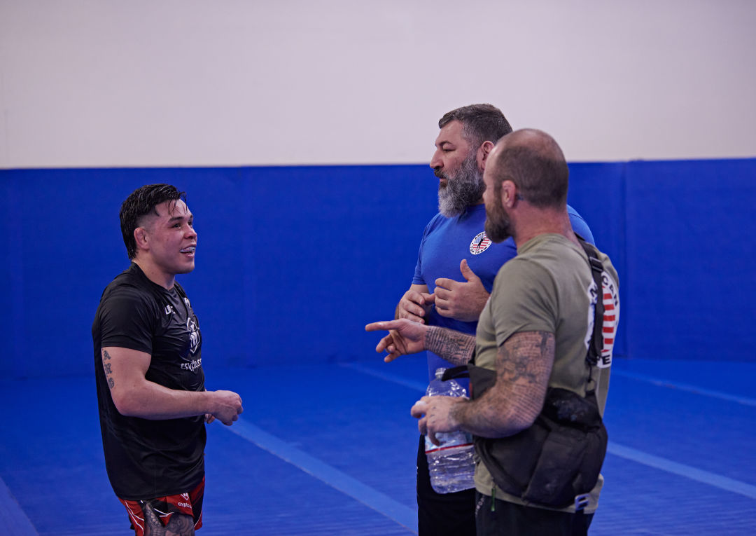 Ricky Simón with coaches Fabiano Scherner and Dylan Fussell at American Top Team in Portland.