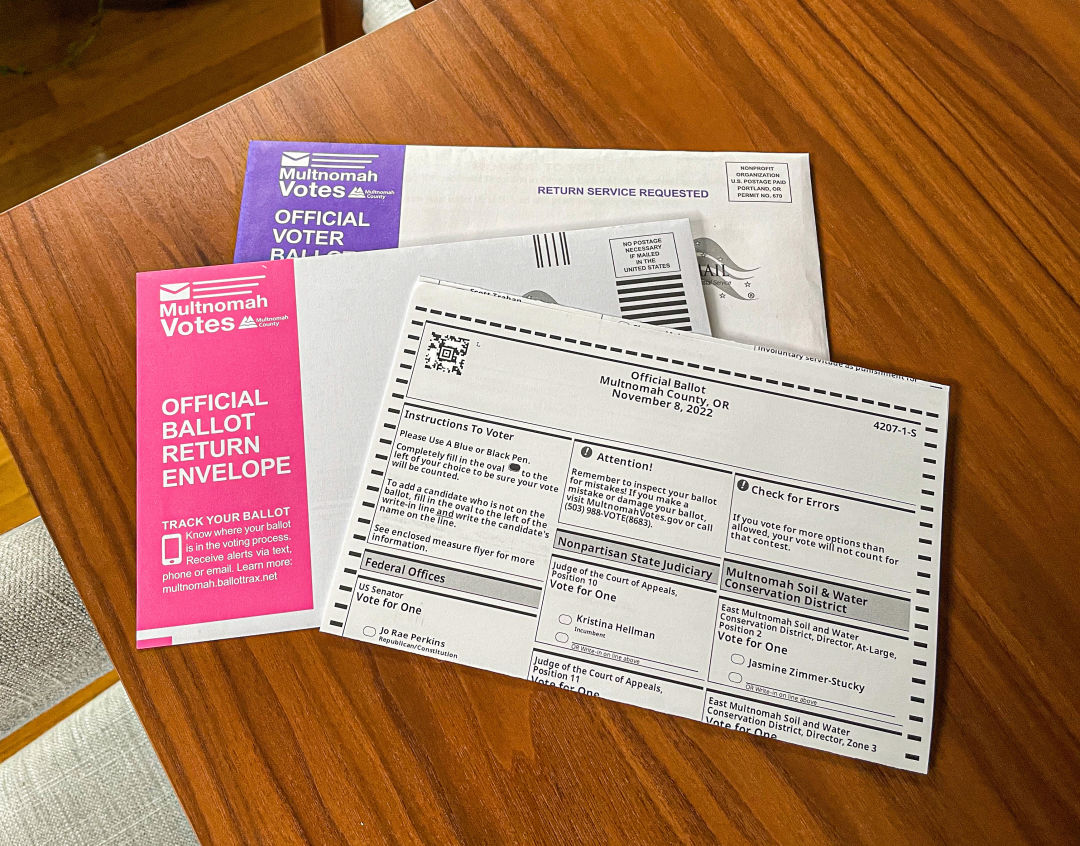 Oregon mail-in ballot and envelopes on a table