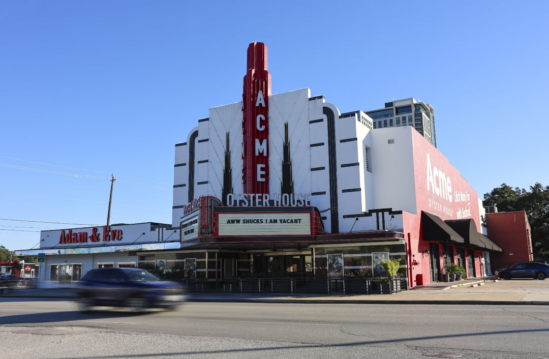 An old theatre building that reads "Acme Oyster House" with a marquee saying "Aww shucks I am vacant."
