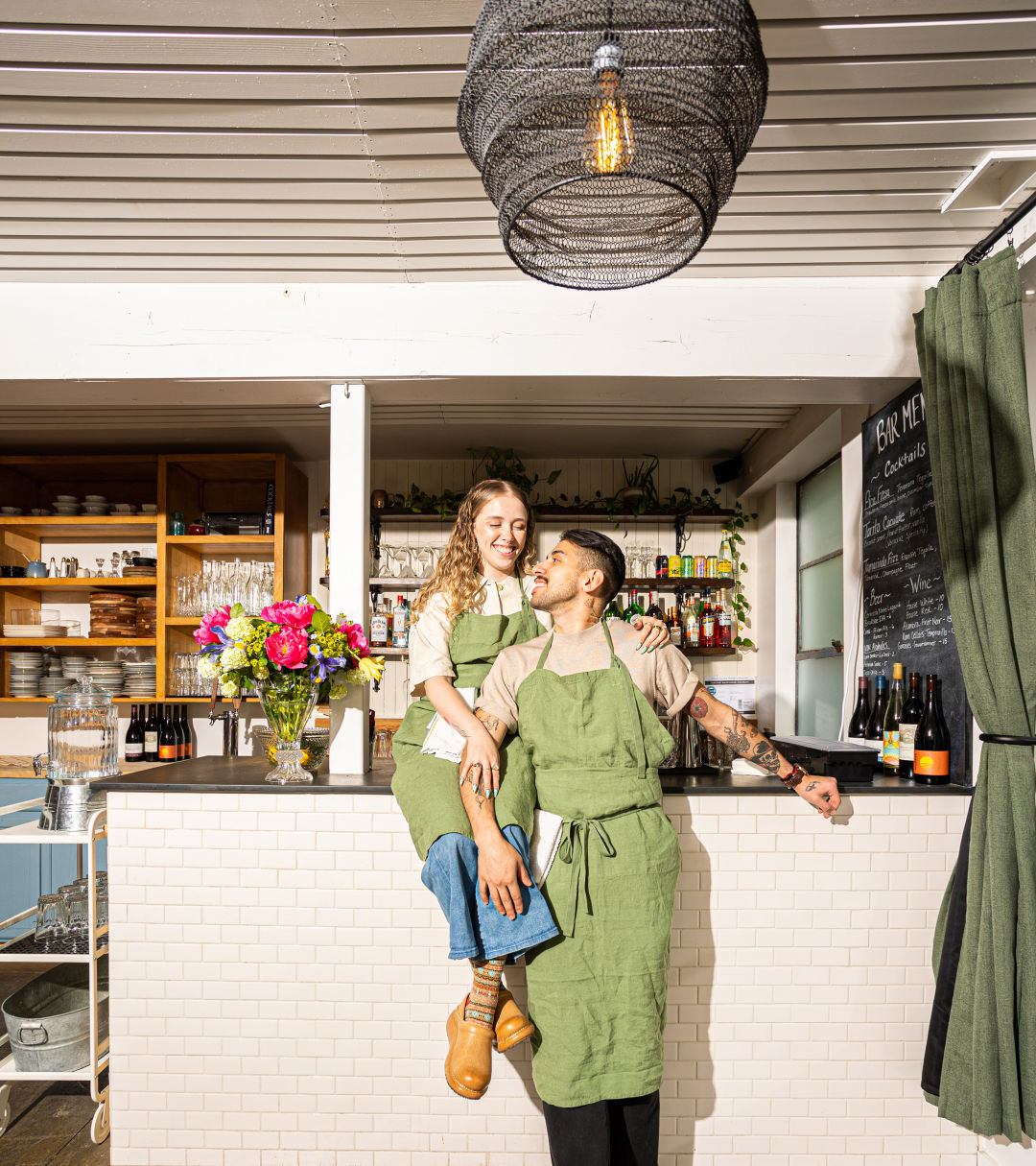 Kautia and Lalo Camarena pose together within the dining room of Che.