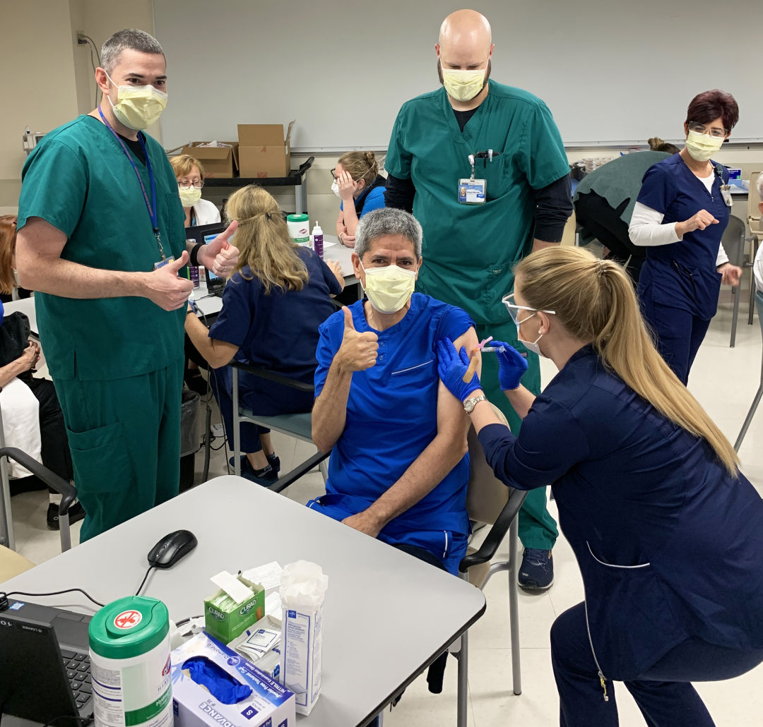 Sarasota Memorial Hospital infectious disease specialist Dr. Manuel Gordillo celebrates the arrival of the  Covid-19 vaccine.