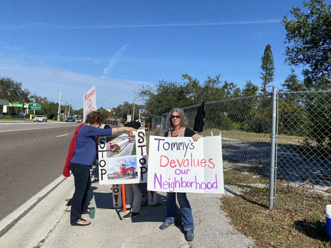 Protesters gathered at the proposed site of a new Tommy's Express Car Wash on the corner of 17th Street and N. Tamiami Trail.