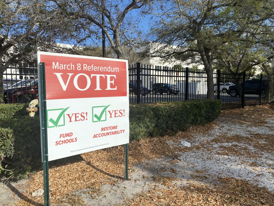 A sign near downtown Sarasota urges residents to vote "yes" on repealing single-member districts and maintaining the property taxes that fund the county's public schools.