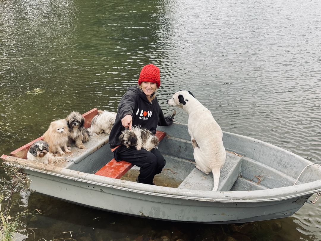 Eva Wolbers with dogs on a small boat in myakka.