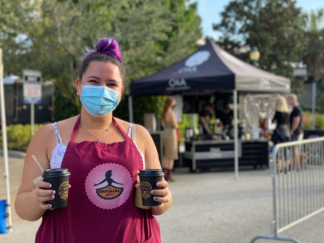 Stefania Fochi of The Empanada Girl, one of the market vendors, with cups of coffee from new vendor O & A Coffee and Supply.