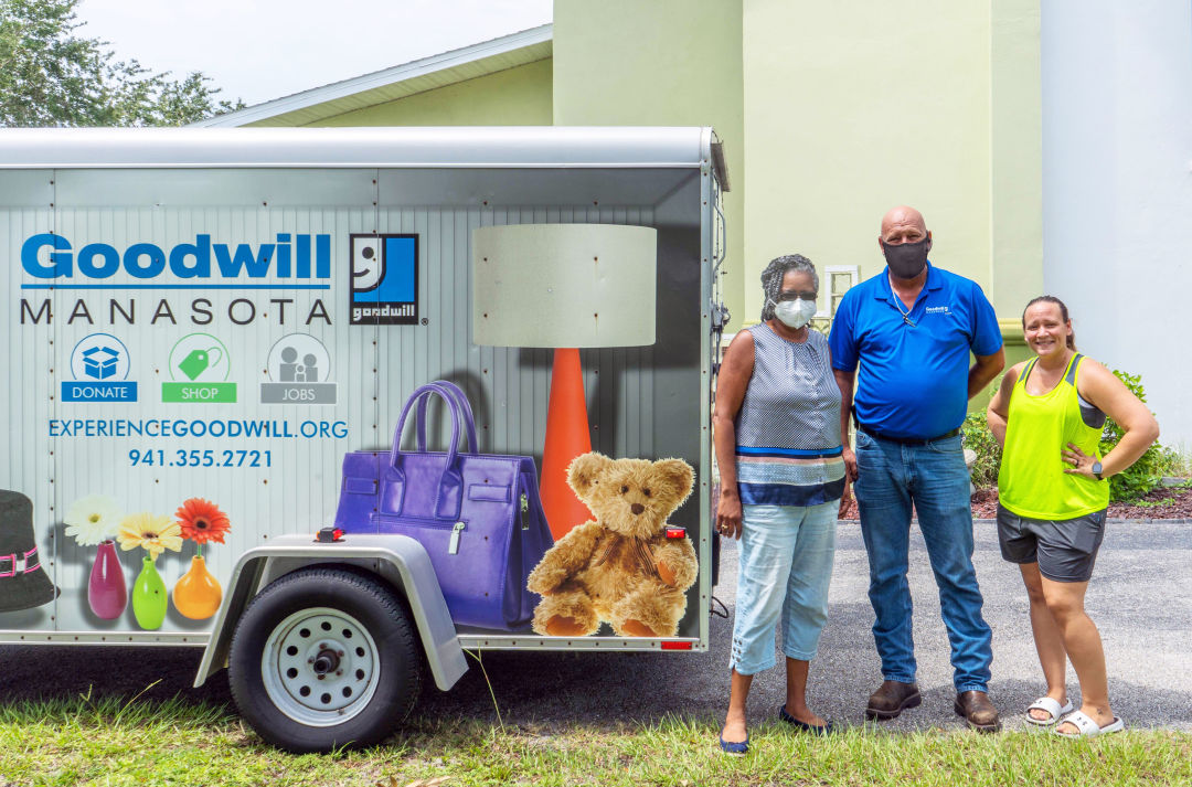 Faith United Methodist Church Pastor Tammie Isidore, Goodwill Manasota's Logistics Manager Russell Phillips, and church volunteer Michelle Millner load donated items bound for Haiti