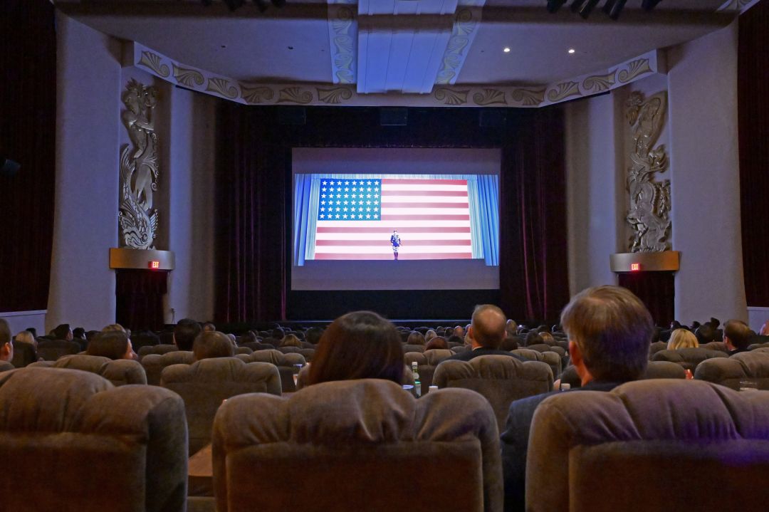 A dine-in art deco movie theater showing Patton on the big screen.