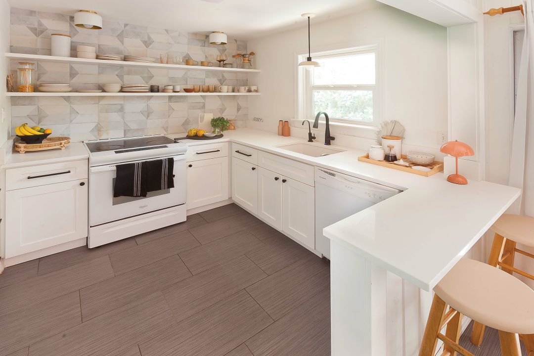 A punched out wall connects the kitchen and the rest of the home and creates an intimate dining bar.